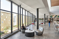  people enjoying a daylit cafeteria space at Lake Highlands High School  