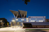 A building at night with large solar overhangs.