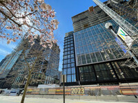 Image of partially complete Amazon Heaquarters with glazing on lower floors and concrete structure still visible in upper floors.