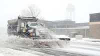 A dump truck snow plow clears snow from Purple Heart Drive during a snow storm March 5, 2015, on Dover Air Force Base, Delaware.