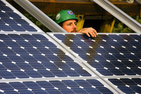 a worker installing solar panels
