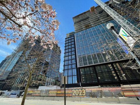 Image of partially complete Amazon Heaquarters with glazing on lower floors and concrete structure still visible in upper floors.