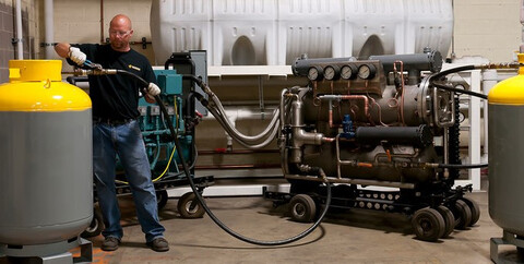 Hudson Technologies’ refrigeration recovery machine in front of HVAC equipment.