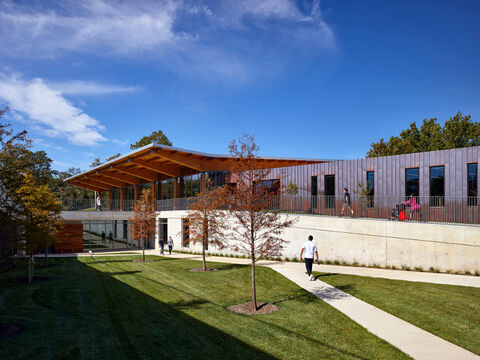 A building with a long walkway and large roof overhang. 