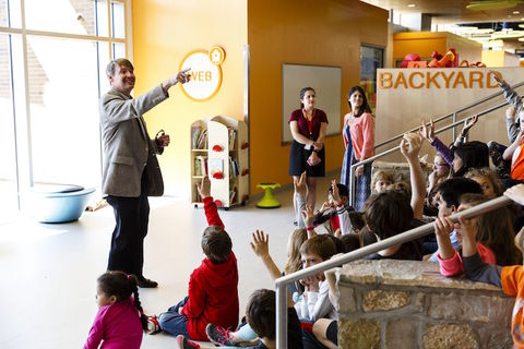 An architect takes questions from a group of school children.